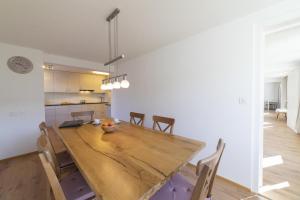 a kitchen and dining room with a wooden table and chairs at Lisighaus in Wildhaus