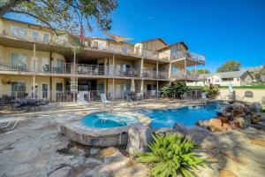 a resort with a swimming pool in front of a building at Walk to Schlitterbahn, River Access & Pets OK in New Braunfels