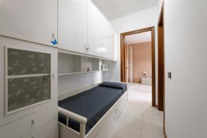 a room with a bed in a classroom with a chalkboard at Casa Acqua Marina vicino al mare con parcheggio privato in Quartu SantʼElena