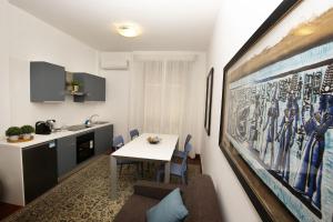 a kitchen and a dining room with a table at Isonzo Home in Cosenza