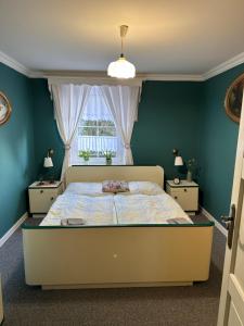 a bedroom with a large bed and a window at Restaurace a penzion u Kulíků in Raspenava