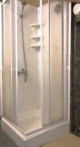 a shower with a glass door in a bathroom at Guest House Niya in Beli Iskar