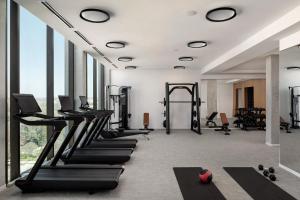a gym with treadmills and elliptical machines at The Loren at Lady Bird Lake in Austin