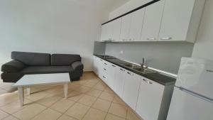 a kitchen with a couch and a table in a room at Queen Residence & Hotel in Shëngjin
