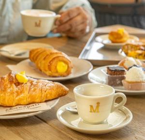 a table with plates of pastries and cups of coffee at Villa Al Piano in Lastra a Signa