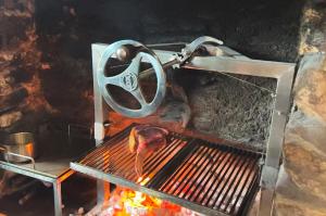 a grill with a steak cooking on top of it at Dartmoor Inn Merrivale in Yelverton