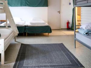 a bedroom with a bunk bed and a rug at Holiday home VÅXTORP II in Våxtorp