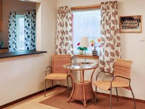 a table and chairs in a room with a window at Holiday home VÅXTORP II in Våxtorp