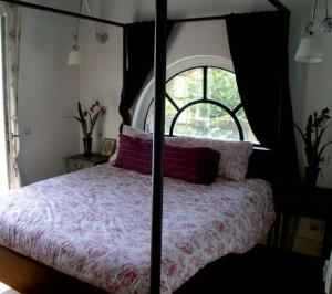 Un pat sau paturi într-o cameră la Villa Giotto