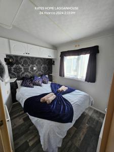 a bedroom with a large bed with two teddy bears on it at Kates Home Lagganhouse Woodland Way 19 in Ballantrae