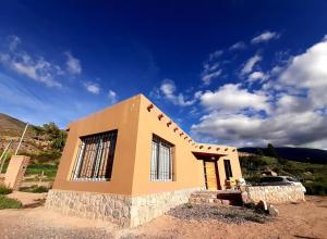 a small house in the middle of a field at Cabaña Huacalera in Huacalera