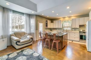 a kitchen with a table and chairs and a refrigerator at Inviting Wasilla Vacation Rental 6 Mi to Big Lake in Wasilla