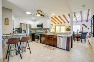 a kitchen with a counter and two bar stools at Modern Prescott Apartment Walk to Downtown! in Prescott