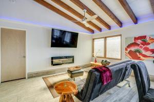 a living room with a couch and a tv at Modern Prescott Apartment Walk to Downtown! in Prescott
