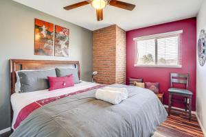a bedroom with a large bed with pink walls at Modern Prescott Apartment Walk to Downtown! in Prescott