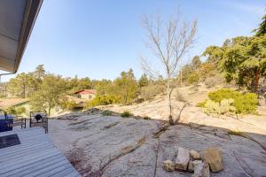 a porch of a house with a tree and rocks at Modern Prescott Apartment Walk to Downtown! in Prescott