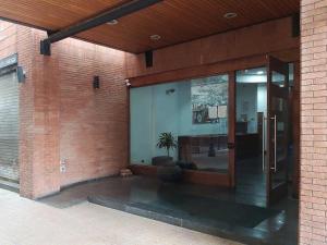 an entrance to a brick building with a glass door at Apartmento en providencia in Santiago