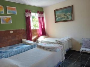 Ένα ή περισσότερα κρεβάτια σε δωμάτιο στο Casa Delicia em Passa Quatro Até 4 pessoas