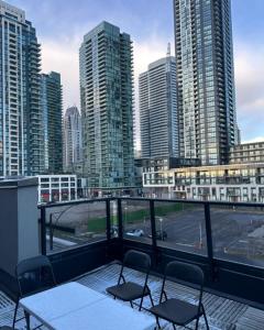 a balcony with a table and chairs and a city at Modern Luxury 3 bed rooms House in Toronto Mississauga in Mississauga