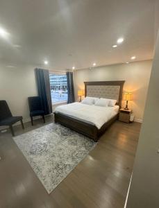 a bedroom with a large bed and a large window at Modern Luxury 3 bed rooms House in Toronto Mississauga in Mississauga