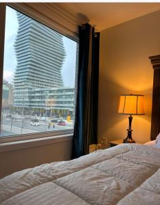 a bedroom with a window with a view of a building at Modern Luxury 3 bed rooms House in Toronto Mississauga in Mississauga