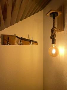 a light hanging from a wall in a room at Casa bunicilor/ Grandparent’s house in Zăbala