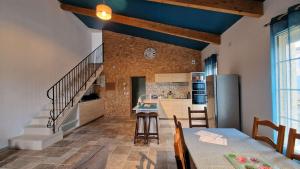 a kitchen and dining room with blue ceilings at Maison bourgeoise de 1881 in Jonzac