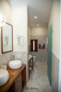 a bathroom with two sinks and a shower at La Regina Luxury Holiday Home in Cava deʼ Tirreni +26 photos