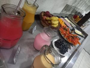 a tray of food with fruit and drinks on a counter at Pousada Aconchego do Tambaú in João Pessoa