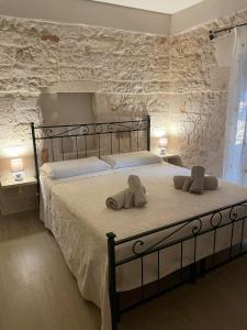 a bedroom with a large bed with towels on it at La casa di pietra in Monopoli
