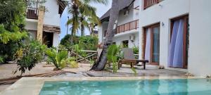 a villa with a swimming pool in front of a house at Ocean View Villa with pool 6, Zanzibar in Pingwe