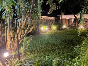 a yard at night with lights in a house at Home Feeling Neneu Lodge in Moshi