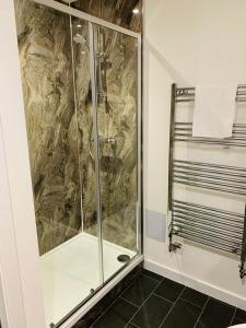 um chuveiro com uma porta de vidro na casa de banho em The Station Hotel em Insch