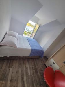 a bedroom with a large bed and a window at Mara village house in Vrlika