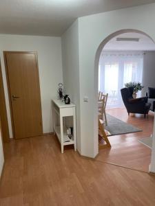 a living room with a door and a room with a table at Tröndles Ferienwohnung in St. Blasien