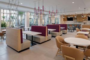 a restaurant with tables and chairs and a bar at Residence Inn by Marriott Chatsworth in Chatsworth