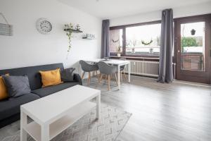 a living room with a couch and a table at Biebrach's Ferienwohnungen in Wilhelmshaven