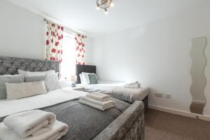 a bedroom with a bed with towels on it at Accessible 2 bedrooms flat + P in Southampton