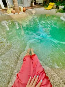 a woman laying on the edge of a swimming pool at Casa Klod Ibiza in Ibiza Town