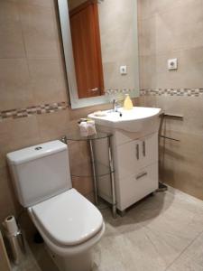 a bathroom with a white toilet and a sink at CASA RO in Tarragona