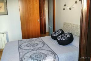 two black and white pillows sitting on a bed at CASA RO in Tarragona