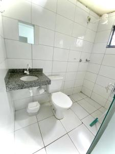 ein weißes Bad mit einem WC und einem Waschbecken in der Unterkunft Pousada Capim Dourado Jalapão São Felix TO in São Félix do Tocantins