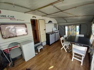 an interior view of an rv with a table and chairs at Caravan near the sea 4 in Ugljan