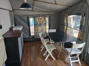 a dining room with a table and chairs in a tent at Caravan near the sea 4 in Ugljan