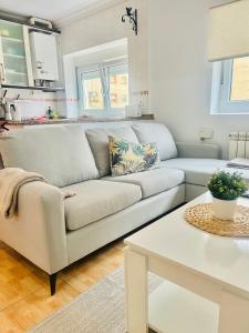 a living room with a couch and a table at Apartamento en Santander in Santander