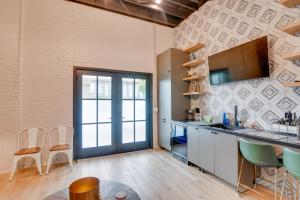 a kitchen with a counter and chairs in a room at Trendy Galveston Getaway - Walk to Downtown! in Galveston