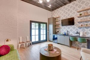 a living room with a couch and a table at Trendy Galveston Getaway - Walk to Downtown! in Galveston
