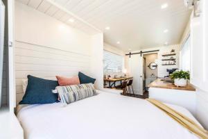 a bedroom with a bed and a desk in a room at New Oak Grove-Container Retreat in Fredericksburg