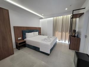 a bedroom with a bed and a television in it at Prestige Hotel in Ksamil