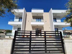 a building with stairs in front of it at Prestige Hotel in Ksamil